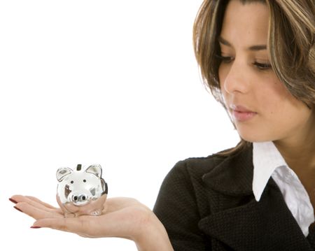 Business woman looking at a piggybank - isolated on white