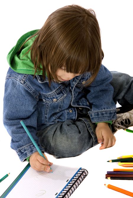 boy colouring on a notebook isolated over a white background