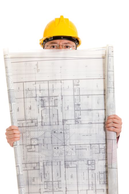 male architect wearing a hard helmet with a building blueprint