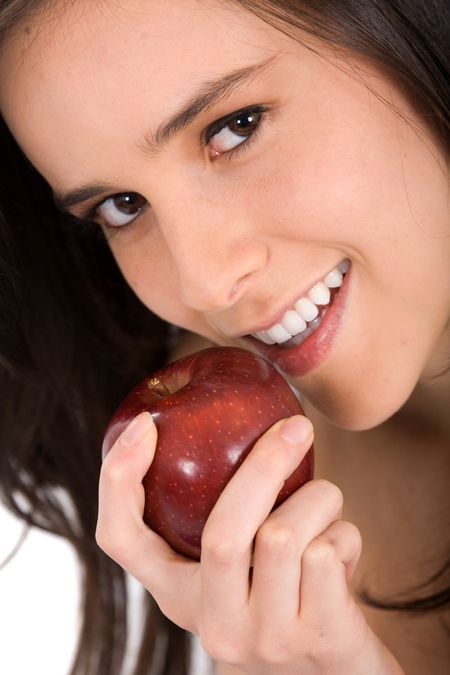 beautiful young girl eating a red apple