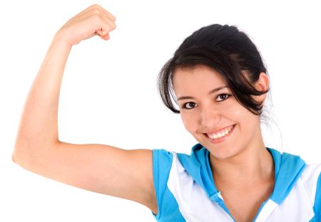 fitness girl showing her biceps and smiling at the camera over a white background