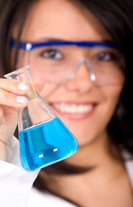 beautiful female scientist holding a bottle with cyan liquid