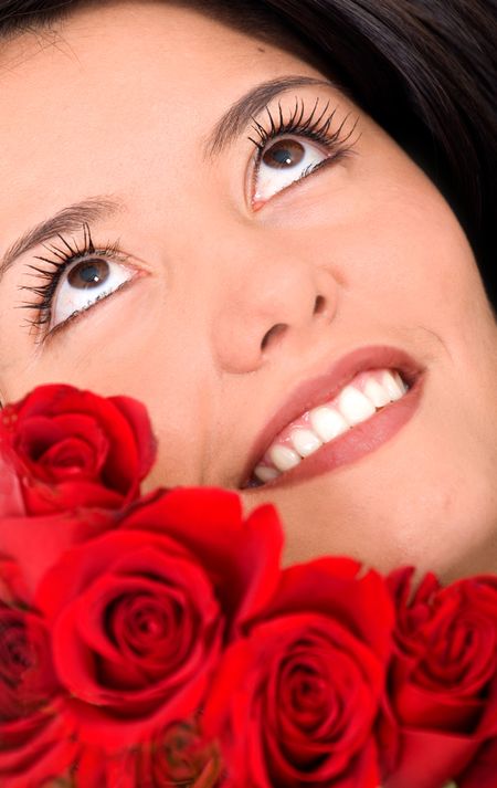 beauty portrait of a girl with roses with a pensive and pleasant face