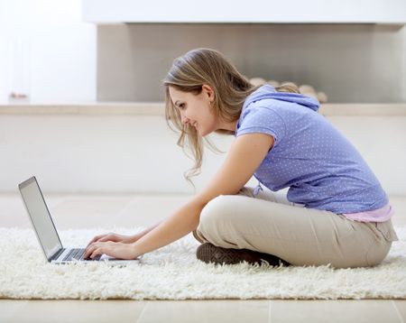 woman with a laptop working from home smiling