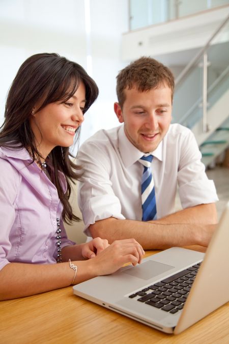 business couple working on a laptop computer at an office