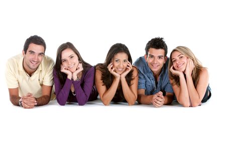 Happy group of friends on the floor isolated over white