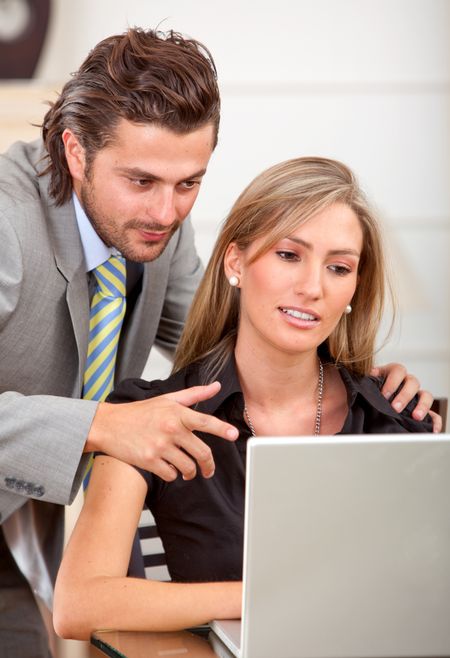 business couple working on a laptop computer at the office