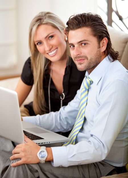 business couple working on a laptop computer from an office
