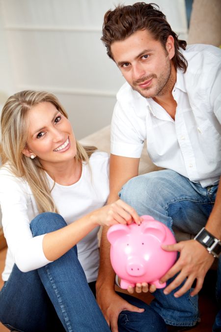 Couple saving money in a piggy bank