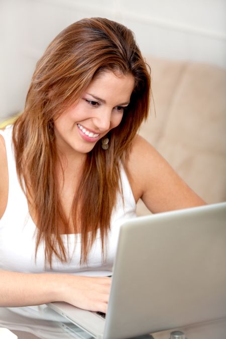 woman with a laptop working from home smiling