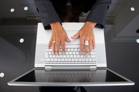 Woman's hand on the keyboard of a laptop computer