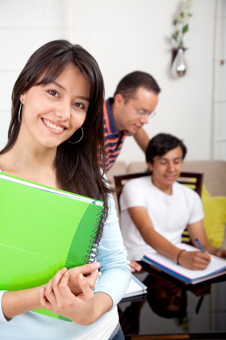 happy student with notebooks and a group of friends behind her