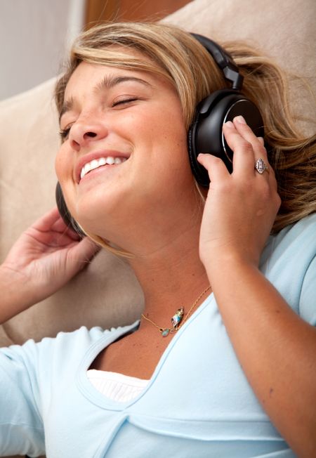 Friendly woman listening to music on her headphones