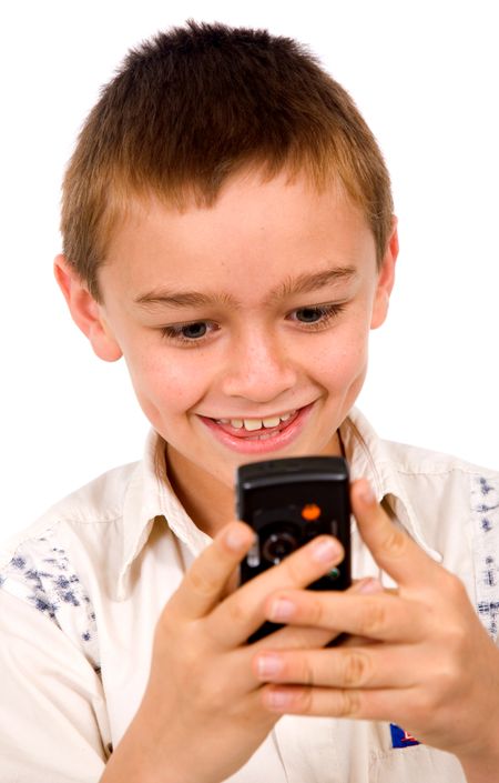 young kid sending an sms on a mobile phone over a white background