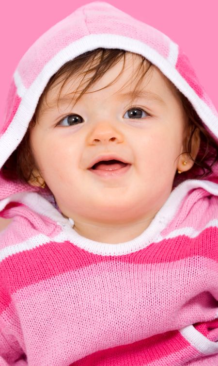 beautiful baby smiling over a pink background