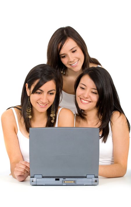 girls dressed in white browsing the web on a laptop