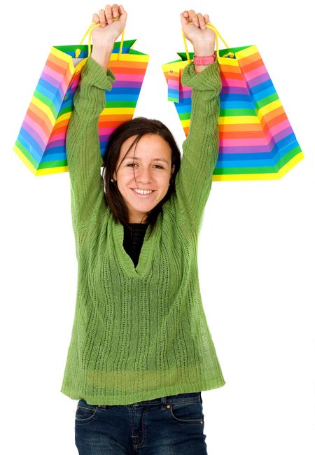 happy girl with shopping bags over a white background