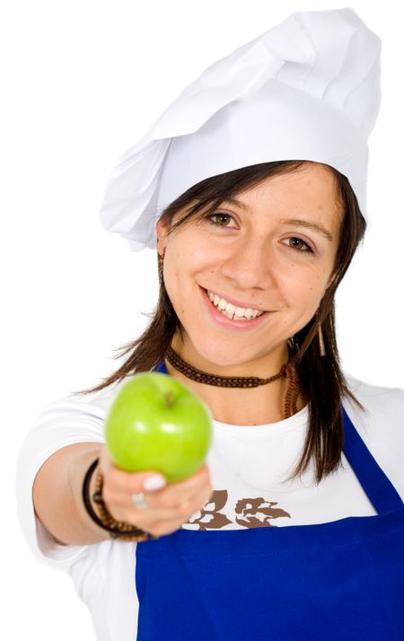 female chef smiling with an apple on her hand over a white background