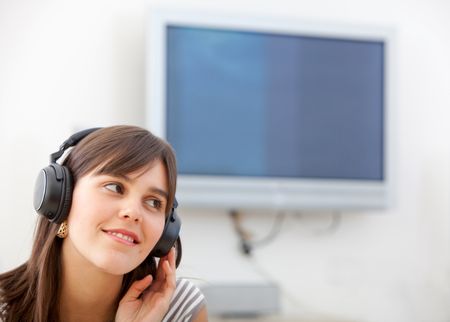 Friendly woman listening to music on her headphones