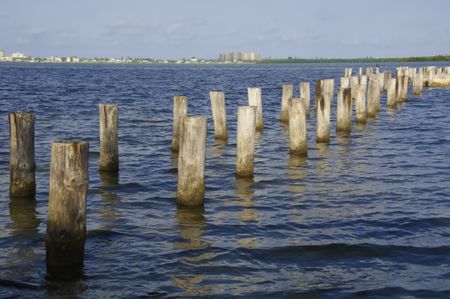 Old dock pilings. Dunedin, Florida, with part of Clearwater Beach on the horizon