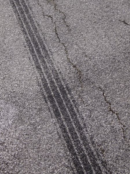 Tire tracks on cracked asphalt