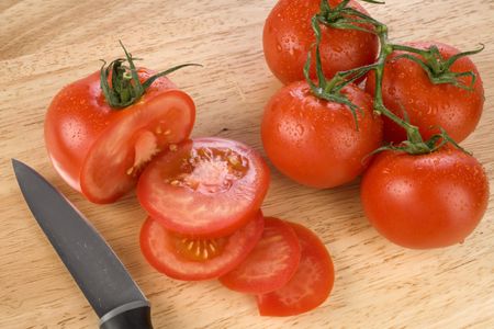 Fresh red tomatoes on a chopping board