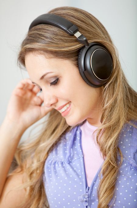 Woman listening to music isolated over a white background