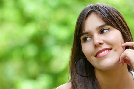 happy woman portrait smiling outdoors in a park