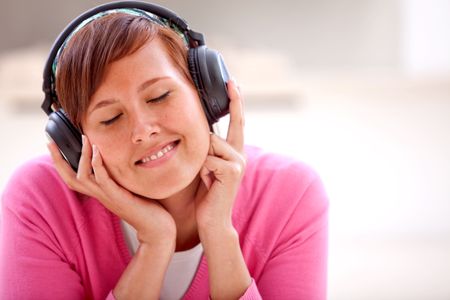 Friendly woman listening to music on her headphones