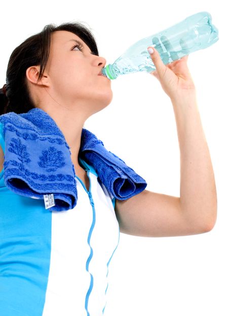 fitness girl drinking water over a white background