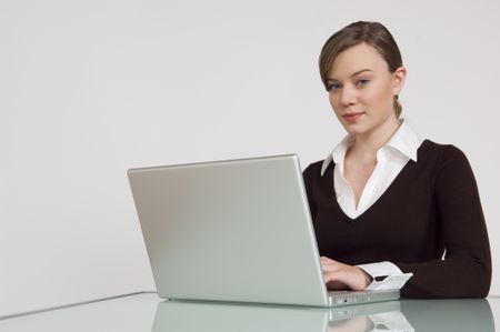 Woman working on a laptop at the office.