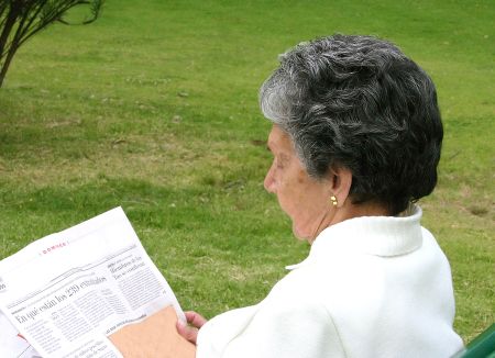 relaxing woman reading newspaper