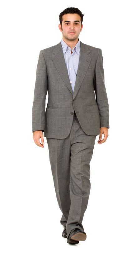 business man walking towards the camera isolated over a white background