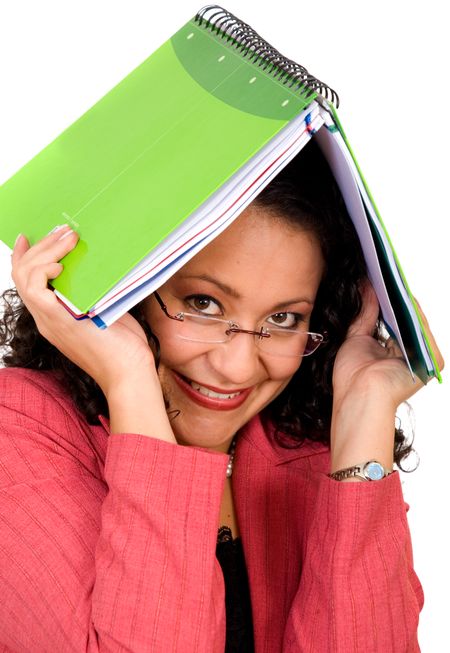 Woman covering herself with a notebook over a white background