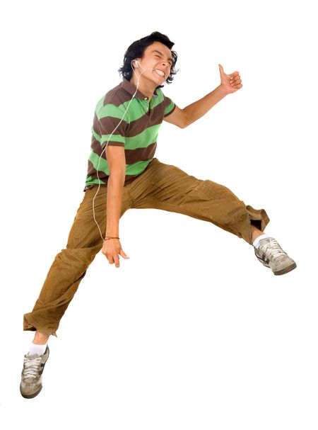 guy enjoying his music jumping in the air isolated over a white background
