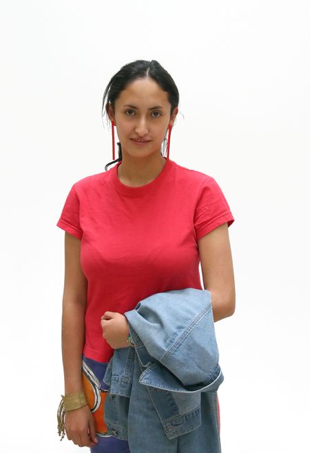 girl facing the camera carrying a jacket