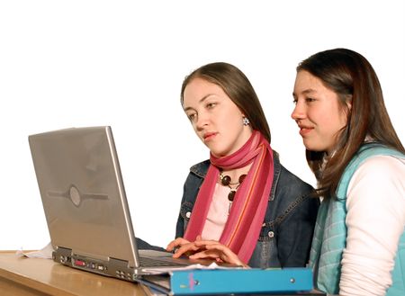 two students working on a laptop
