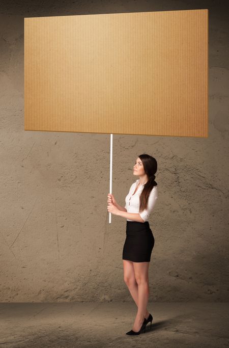 Young businesswoman holding a blank cardboard 