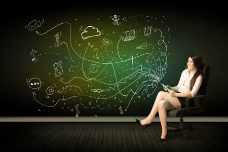 Businesswoman sitting in chair holding tablet with media icons concept on background