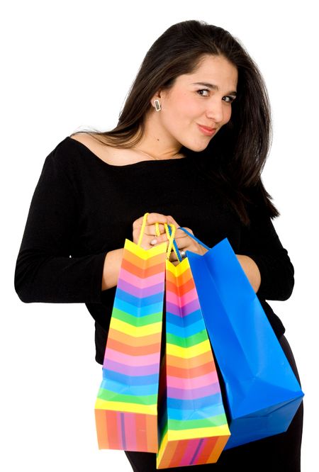 Beautiful girl with shopping bags smiling over a white background
