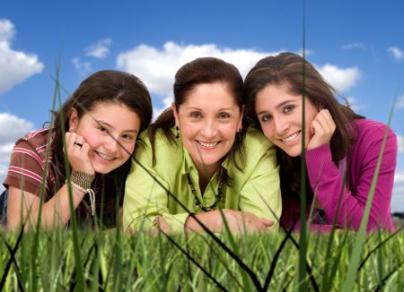 Happy Family portrait outdoors in a park where all are smiling