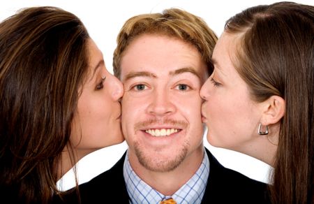 Business man with two girls kissing him at the same time isolated over a white background