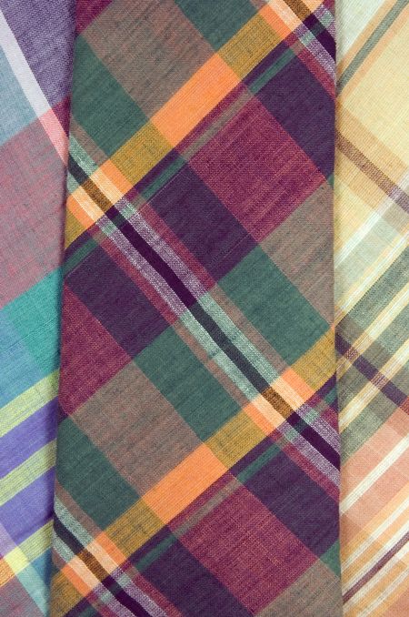 Plaid necktie, fall colors, on top of two others