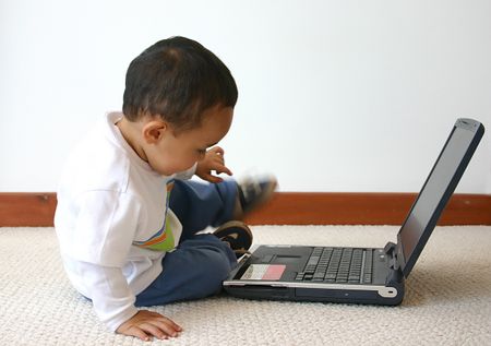 little boy playing around with his laptop