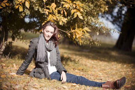Woman relaxing and resting on the floor on a beautiful autumn sunny day
