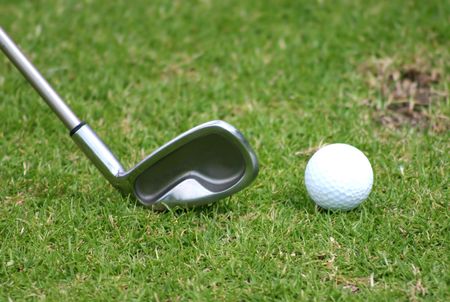 golf club with ball next to it