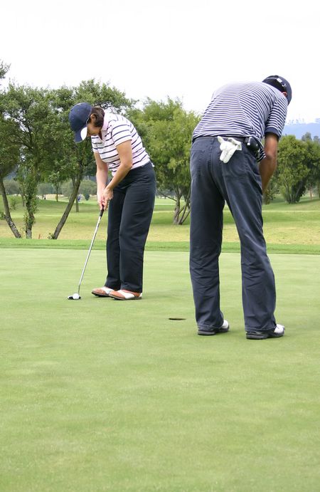 couple of golfers practising