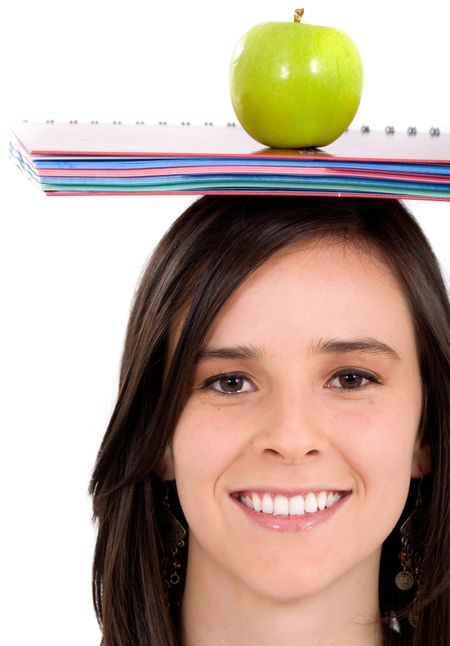 casual intelligent student with a notepad and an apple on her head - isolated over a white background
