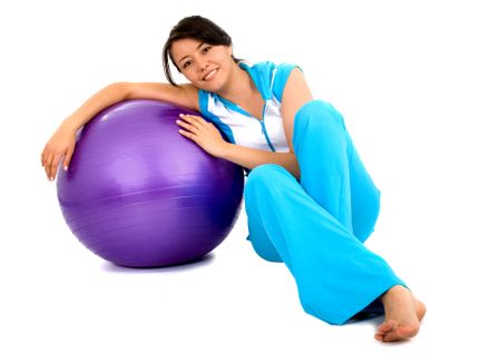 Casual Girl with a pilates ball isolated over a white background