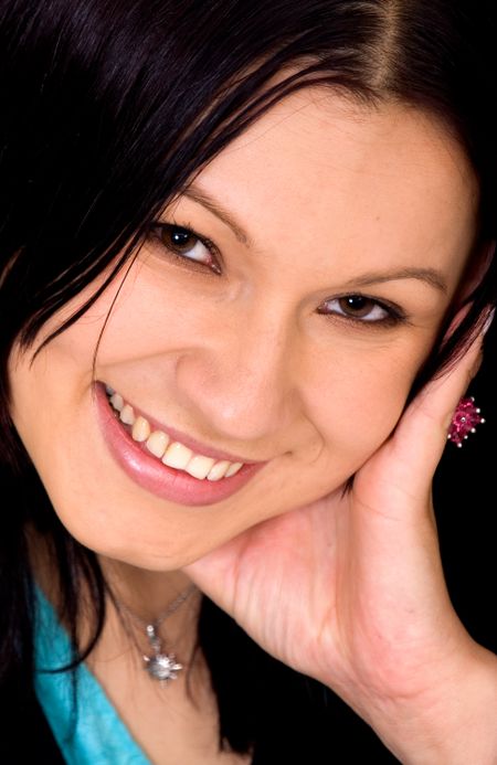 girl smiling in a portrait with her hand on her face